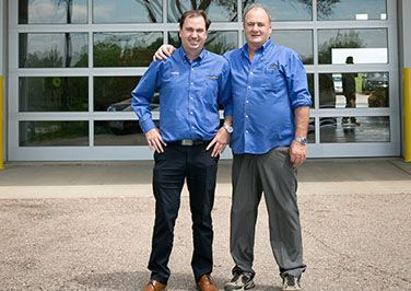 Two staff members outside of shop | Grahams Auto & Truck Clinic