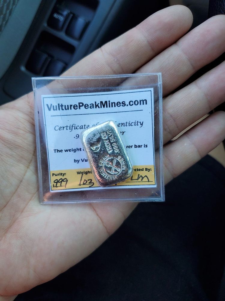 Person is Holding a Small Silver Ba — Orange, CA — Patchin's Coin Gallery Inc.
