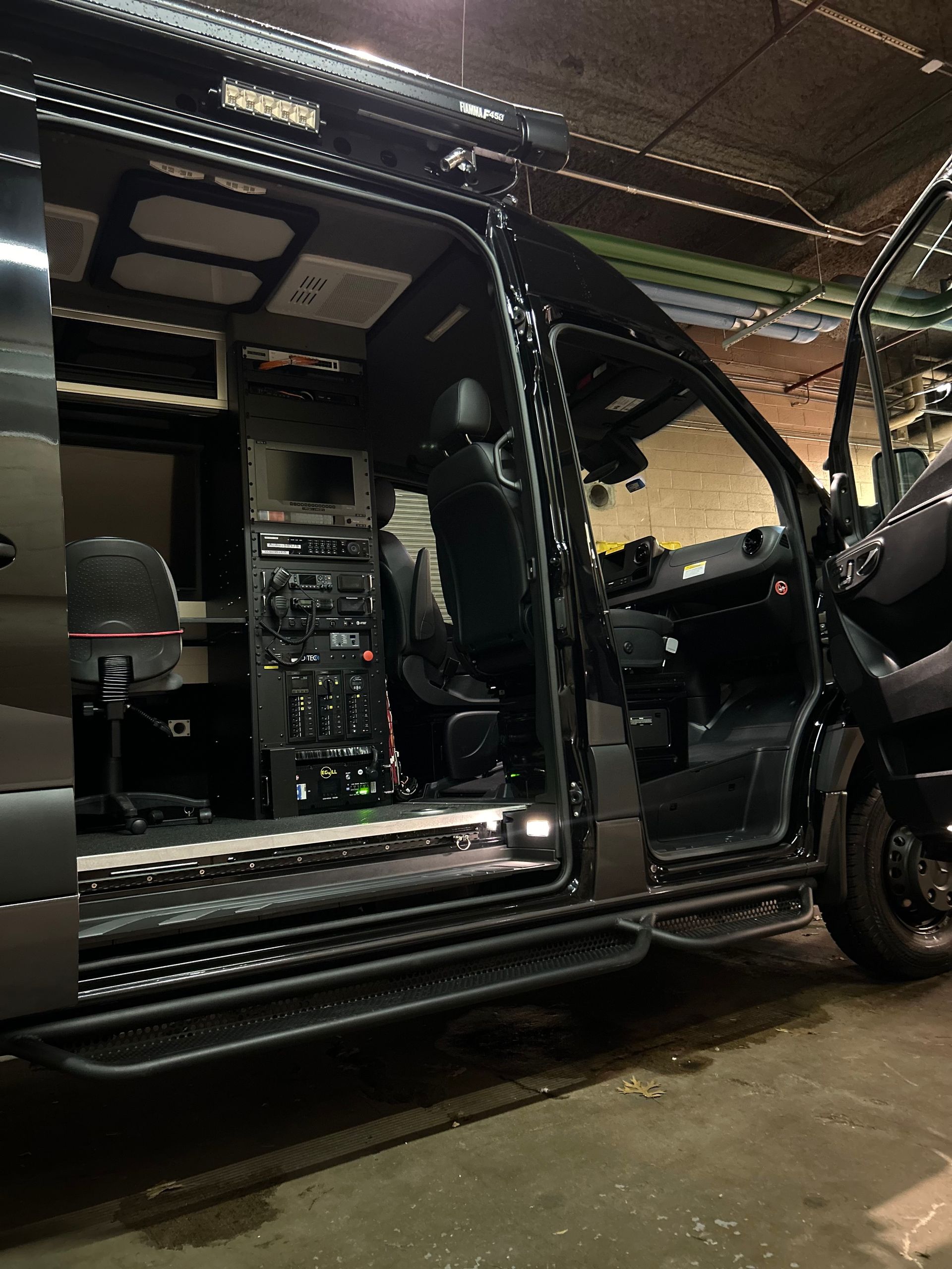 Mercedes-Benz Sprinter mobile command van interior with open sliding door, clean cabin and equipment layout after detailing