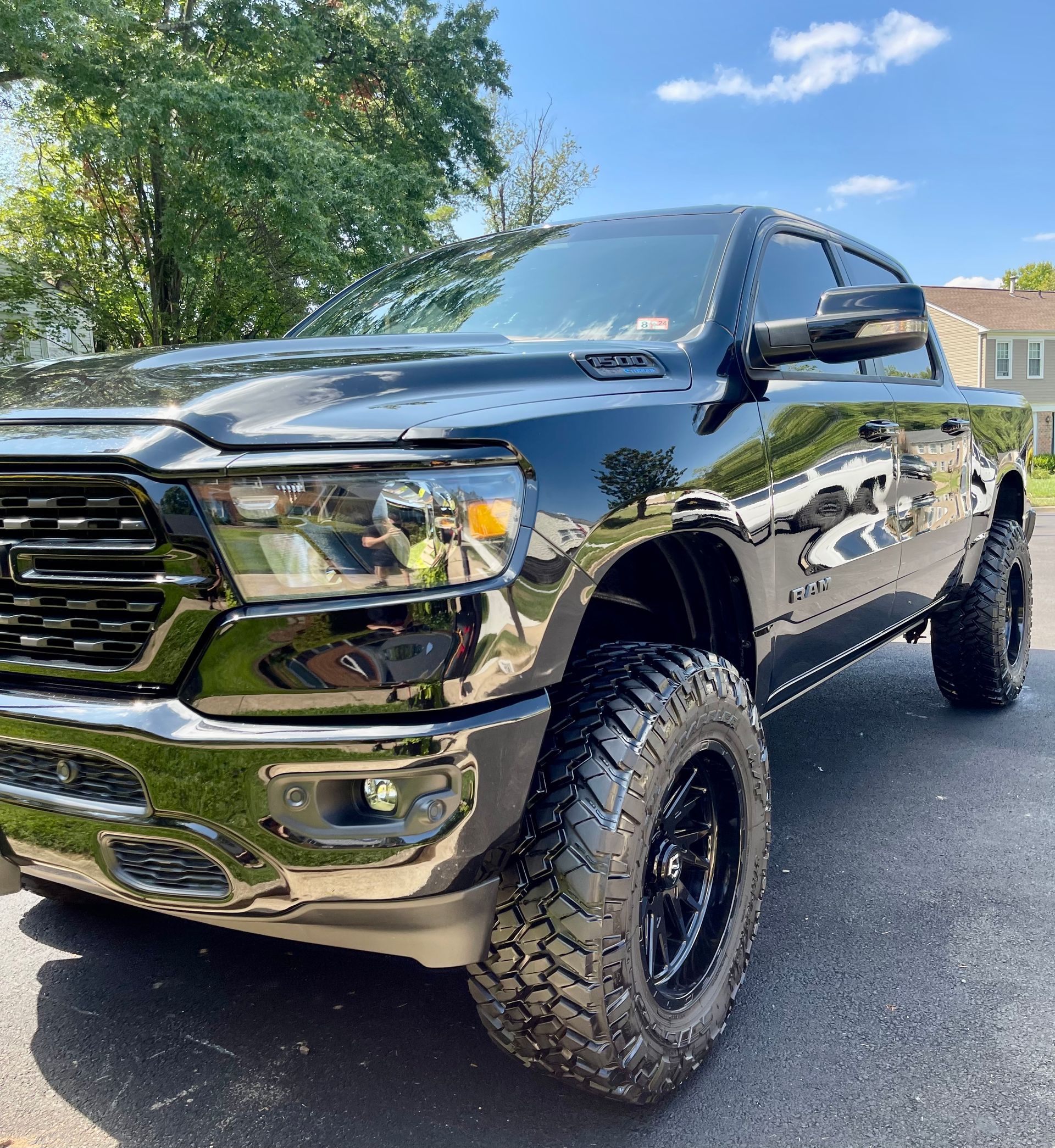 Black Ram 1500 pickup truck with lifted stance, clean paint, detailed tires, and polished exterior surfaces