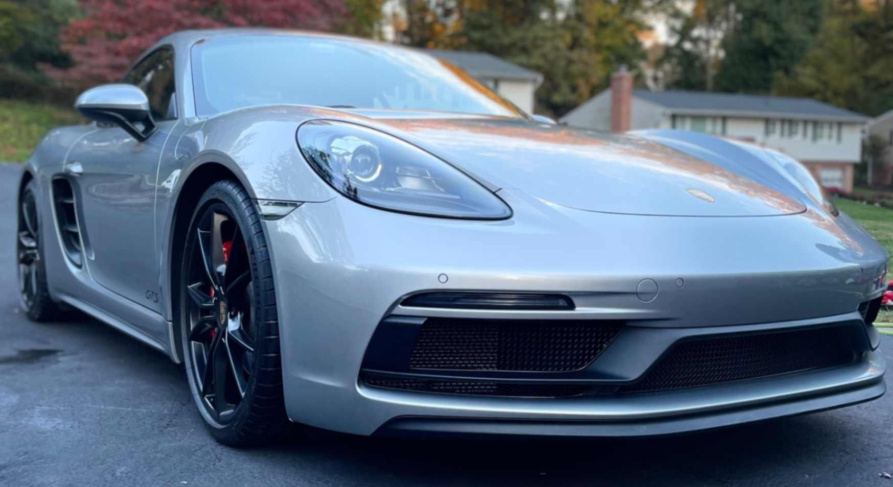 Porsche 718 Cayman GTS in silver with crisp reflections, clean wheels, and smooth finish after meticulous wash and sealant.
