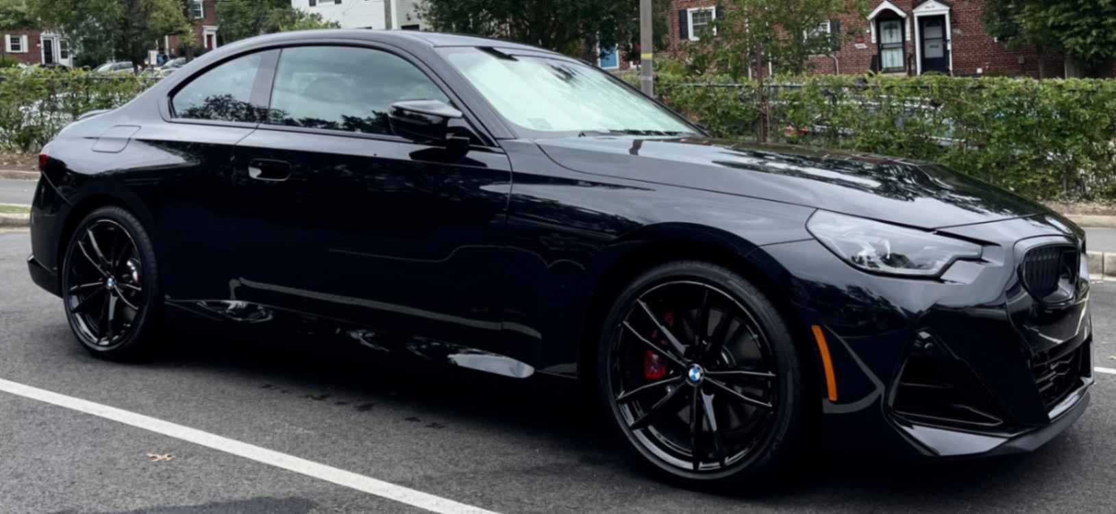 BMW 2 Series coupe with crisp reflections, clean wheels, and a glossy finish after a meticulous wash.
