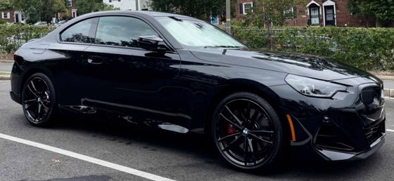 BMW 2 Series coupe with crisp reflections, clean wheels, and a glossy finish after a meticulous wash.