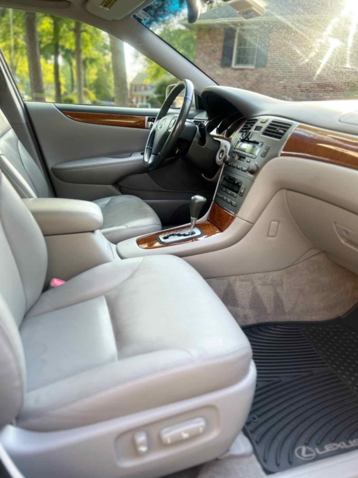 Lexus sedan light leather interior with cleaned seats, wood trim, and refreshed cabin materials.