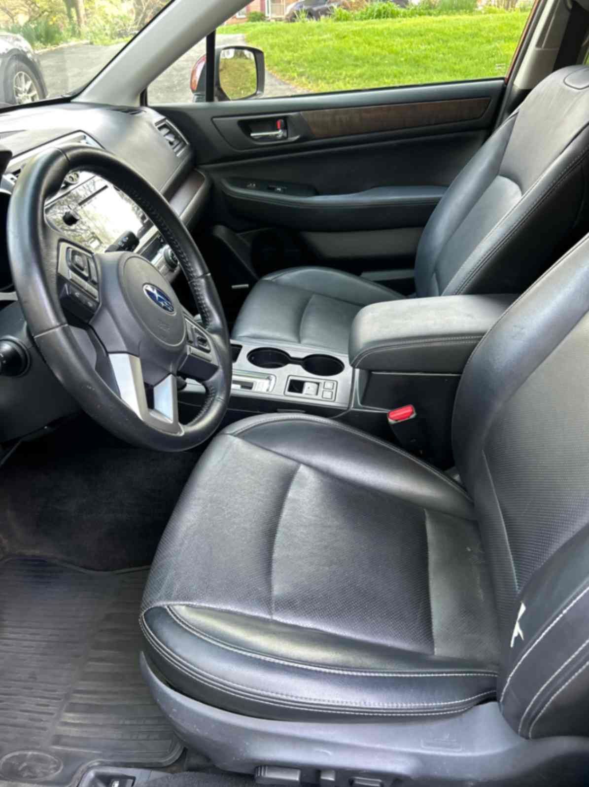 Subaru black leather front-seat interior after cabin cleaning and material-safe treatment.