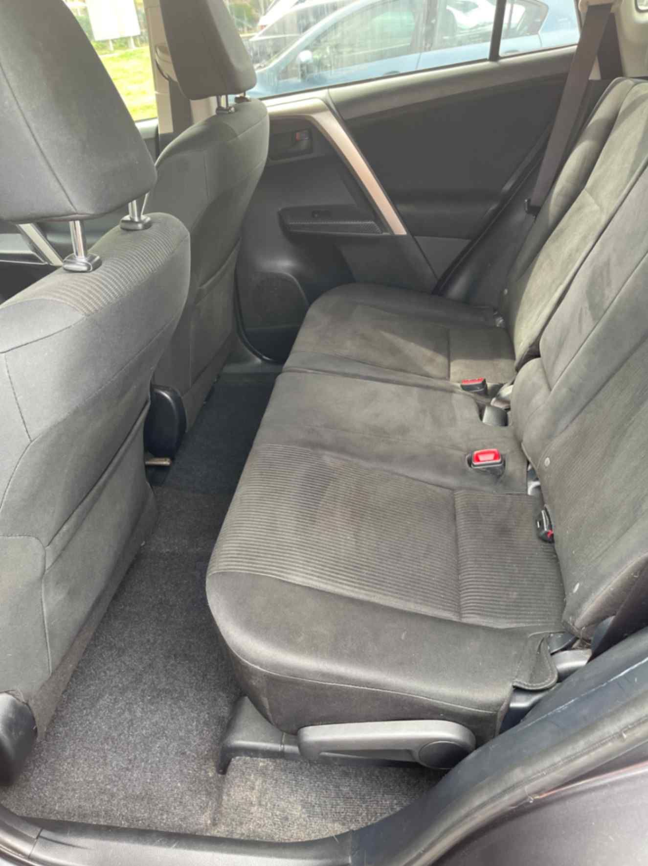 Black cloth SUV rear seating area after interior cleaning and material-safe care.