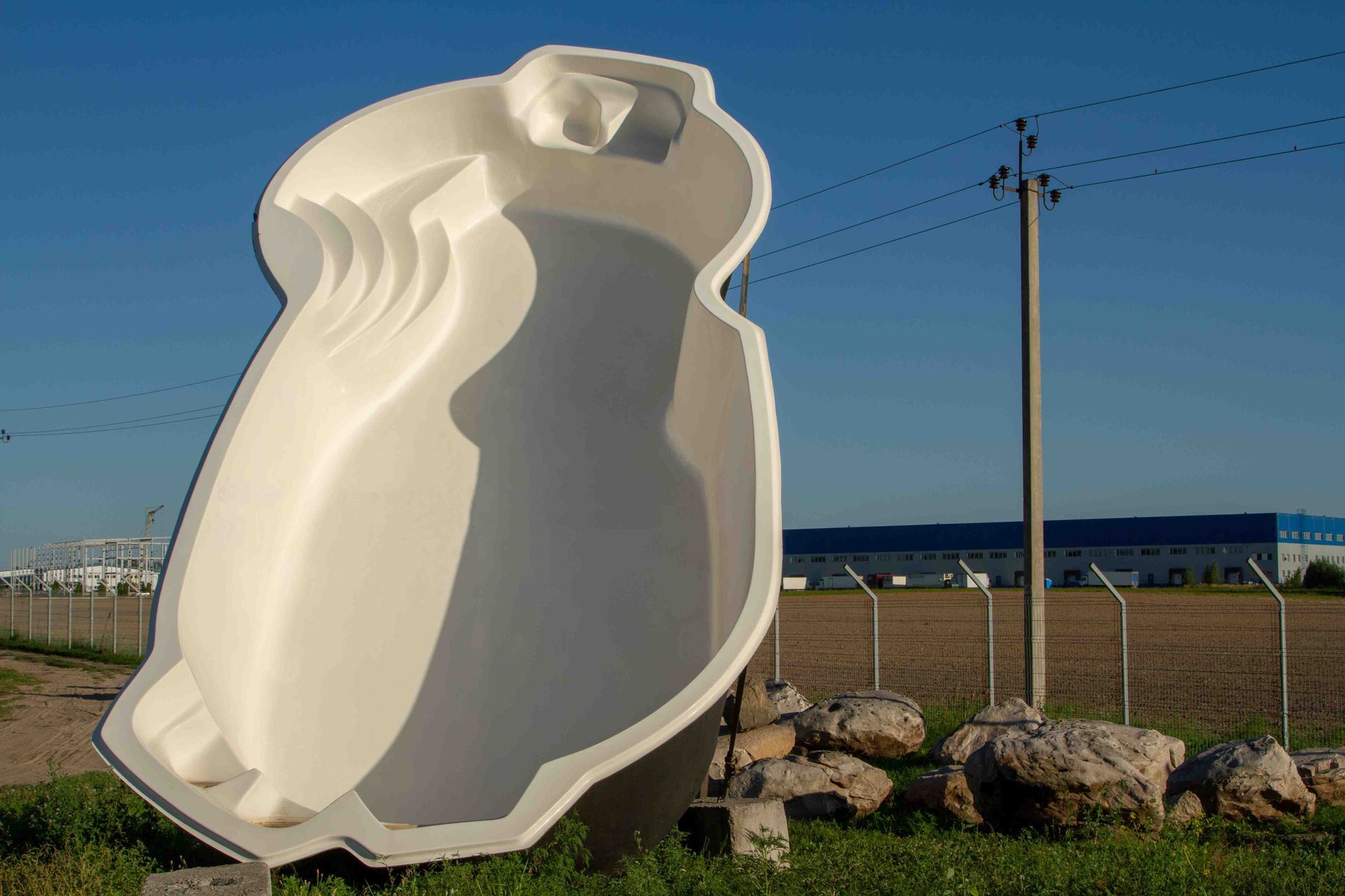 A fiberglass pool up on its side, before it is in stalled