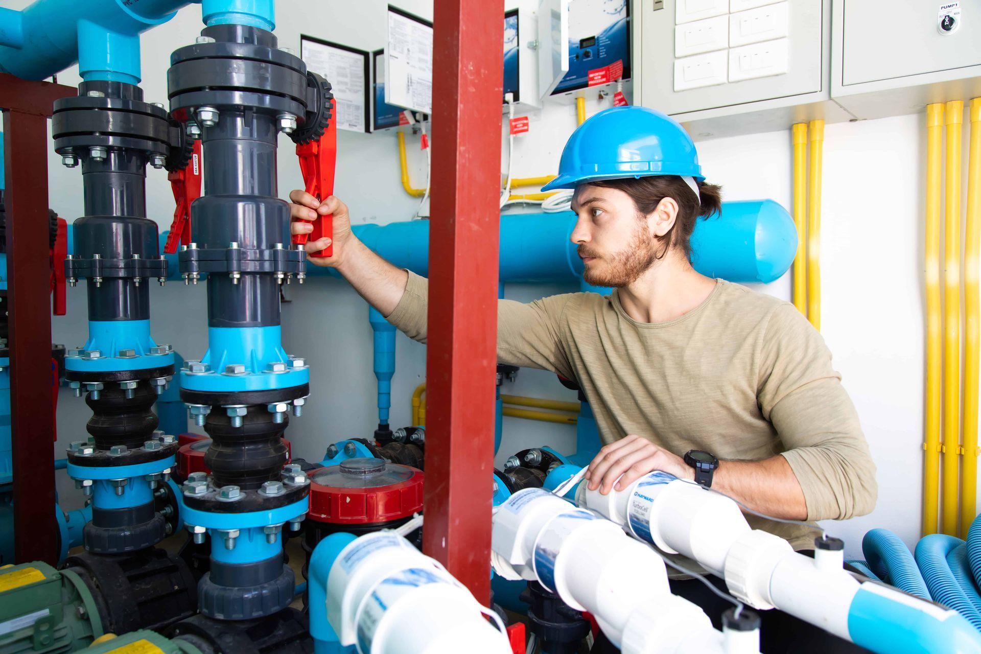 A man maintaining a swimming pool equipment