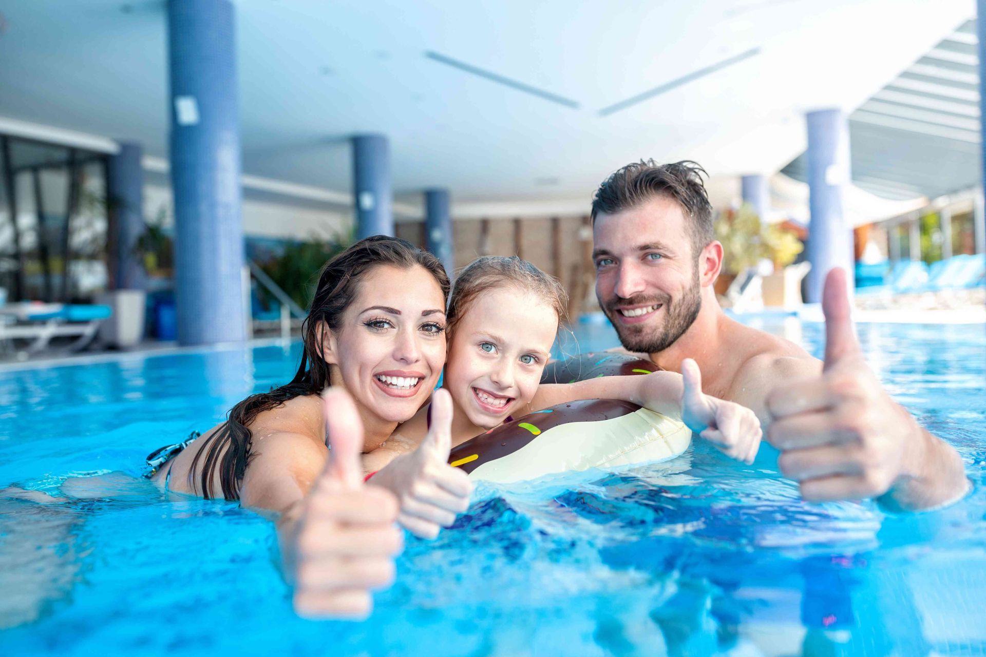 Mother, Father, and child in a pool