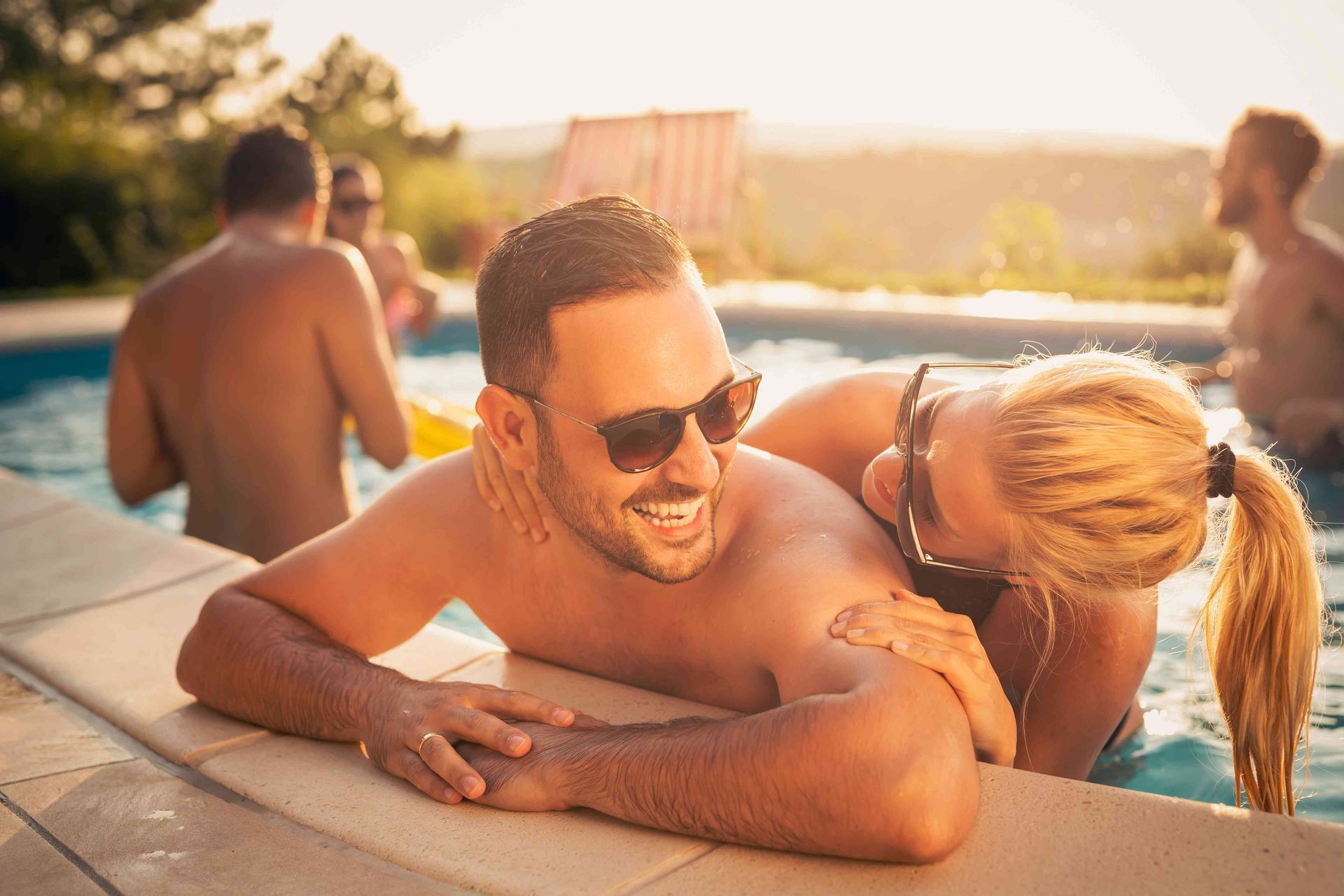 Friends having a blast in their pool outside