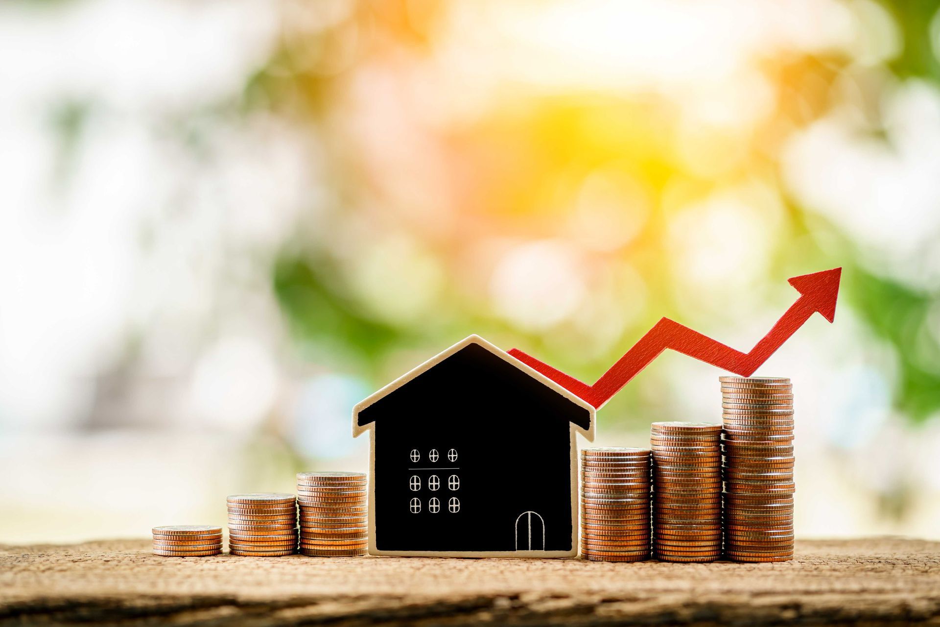 A picture of a house with coins by it to portray rising home value