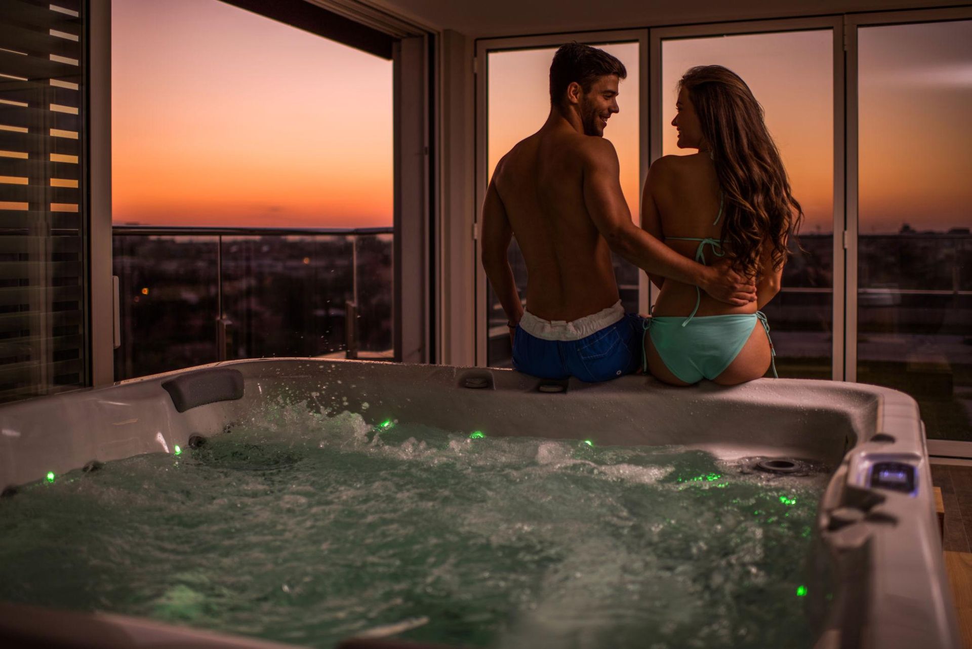 A couple watching Aurora Borealis from their hot tub