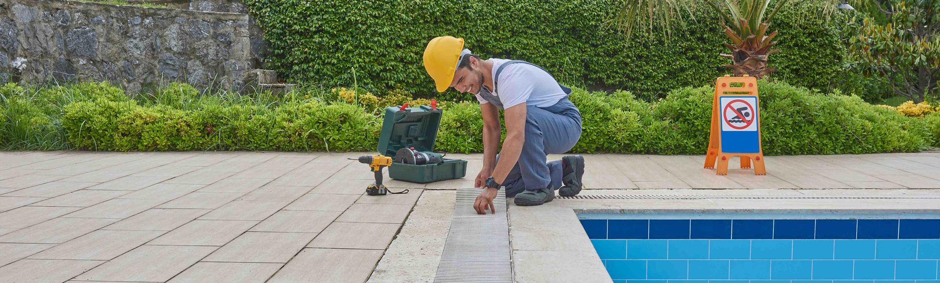 A man working on a pool repair job
