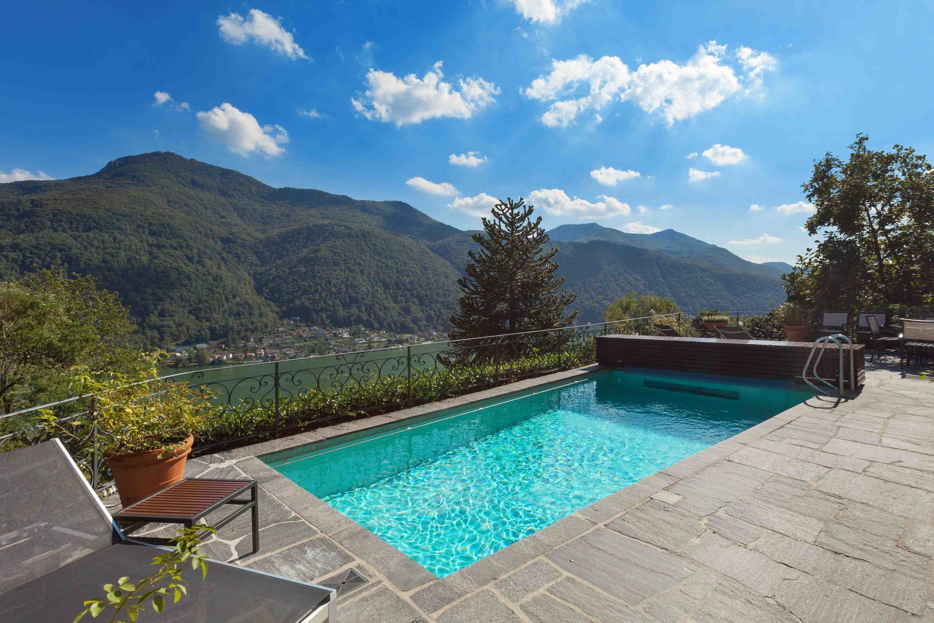 A pool up on higher ground with a cool view of a river below