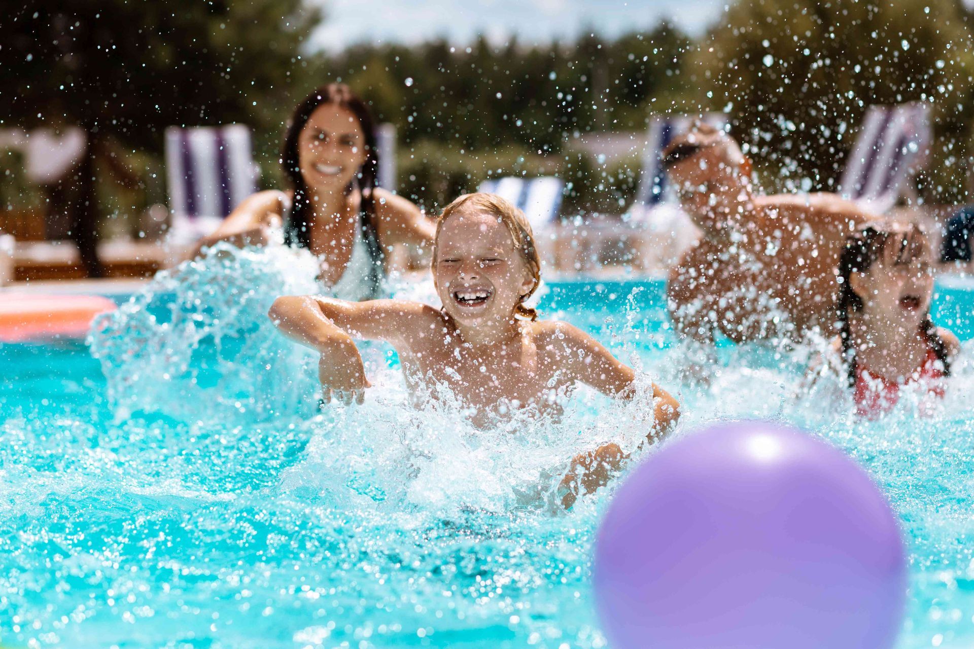 A family having fun in their swimming pool