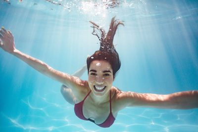 A woman swimming in her pool at her home in the North Texas Area
