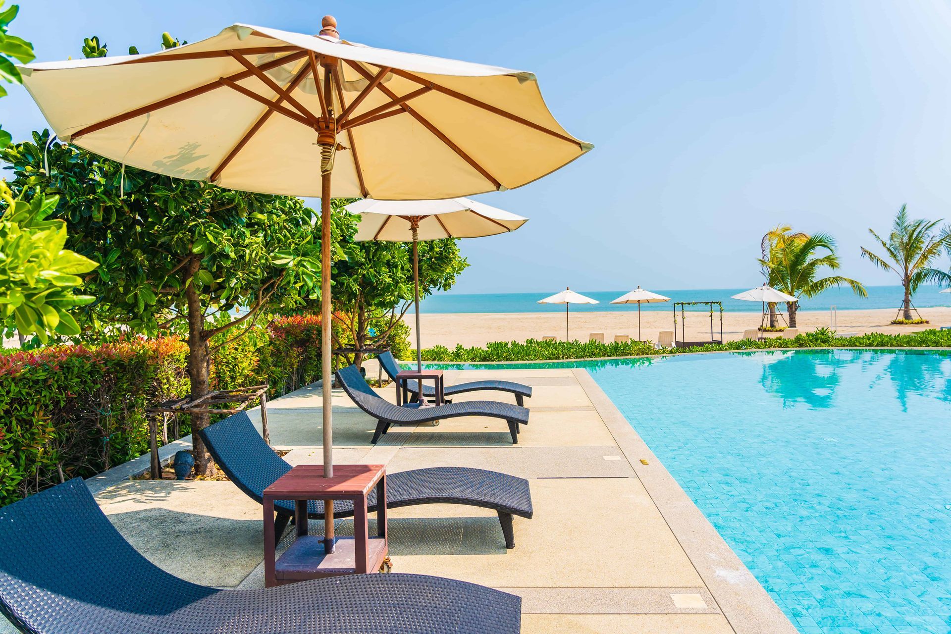 Umbrellas and reclining chairs by a swimming pool