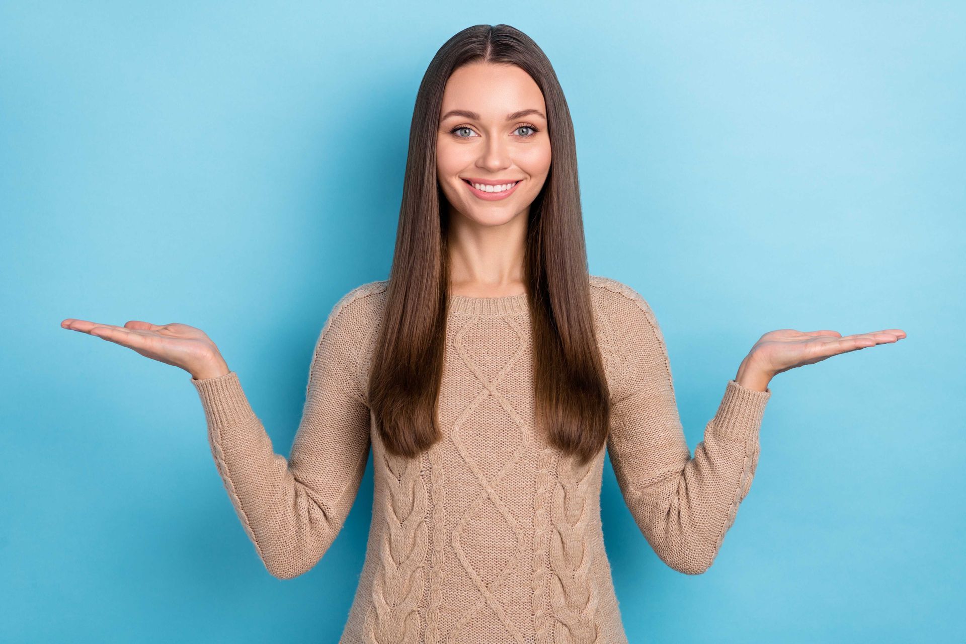A woman with hands out so as to weigh two options