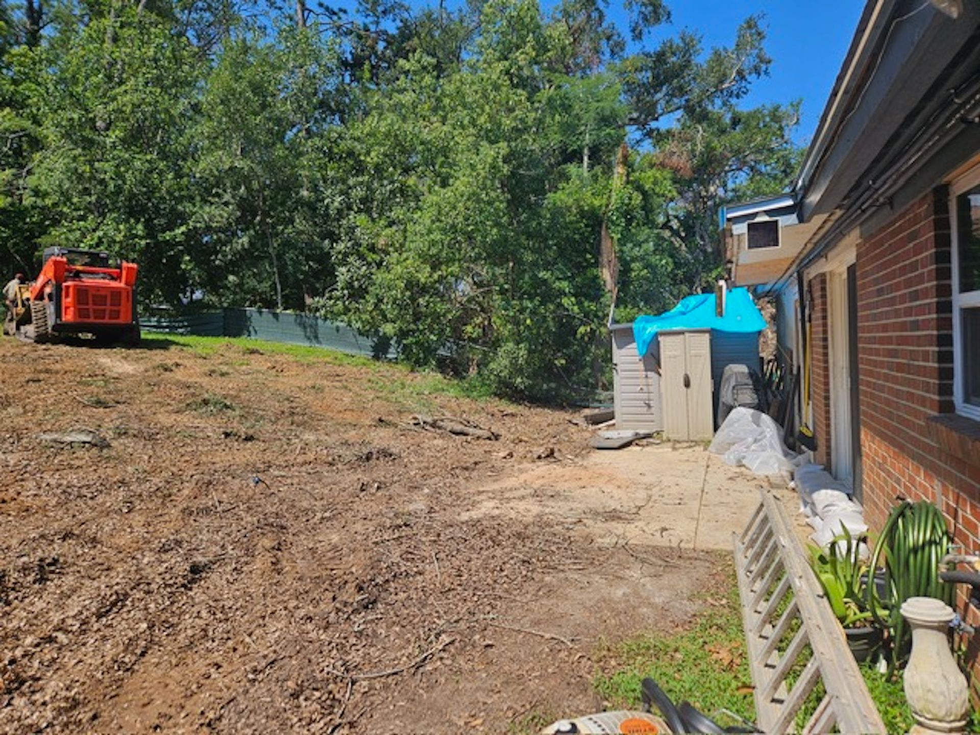 A brick house with a lot of dirt in front of it.