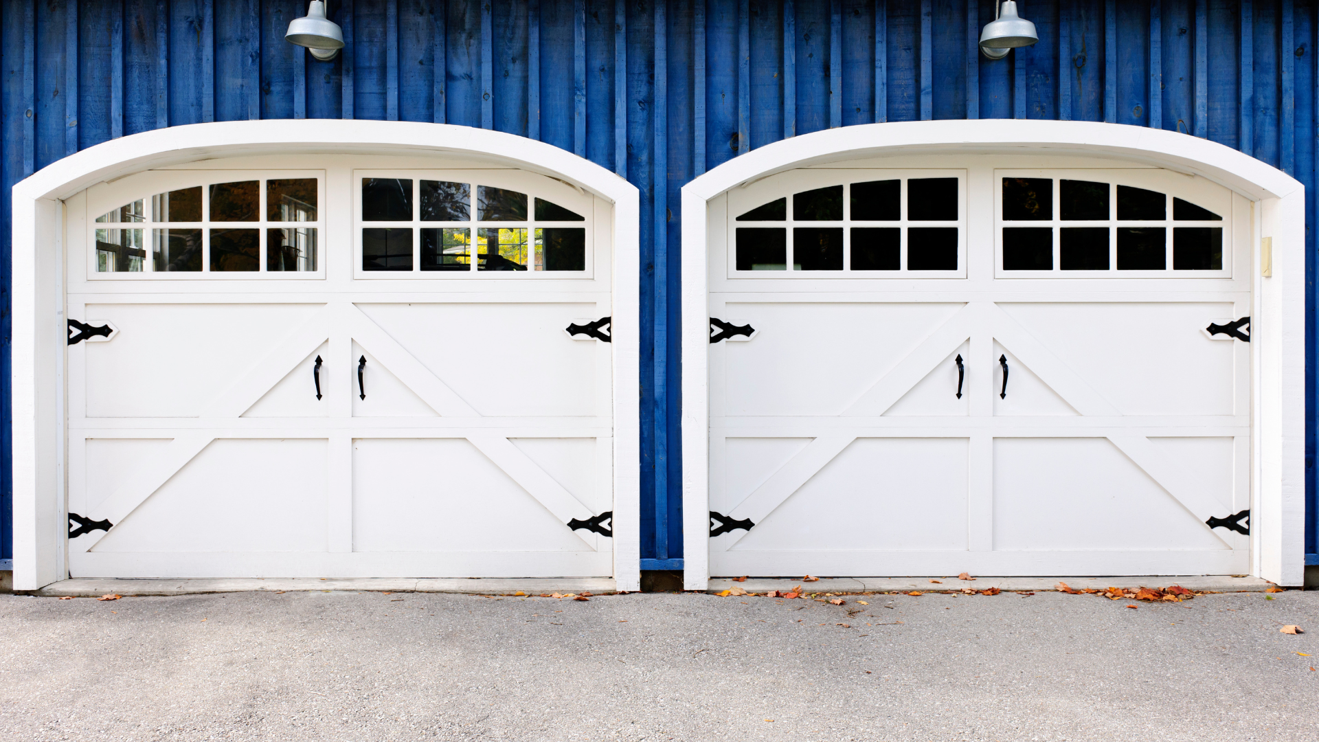 An empty garage with a sink and a garage door.