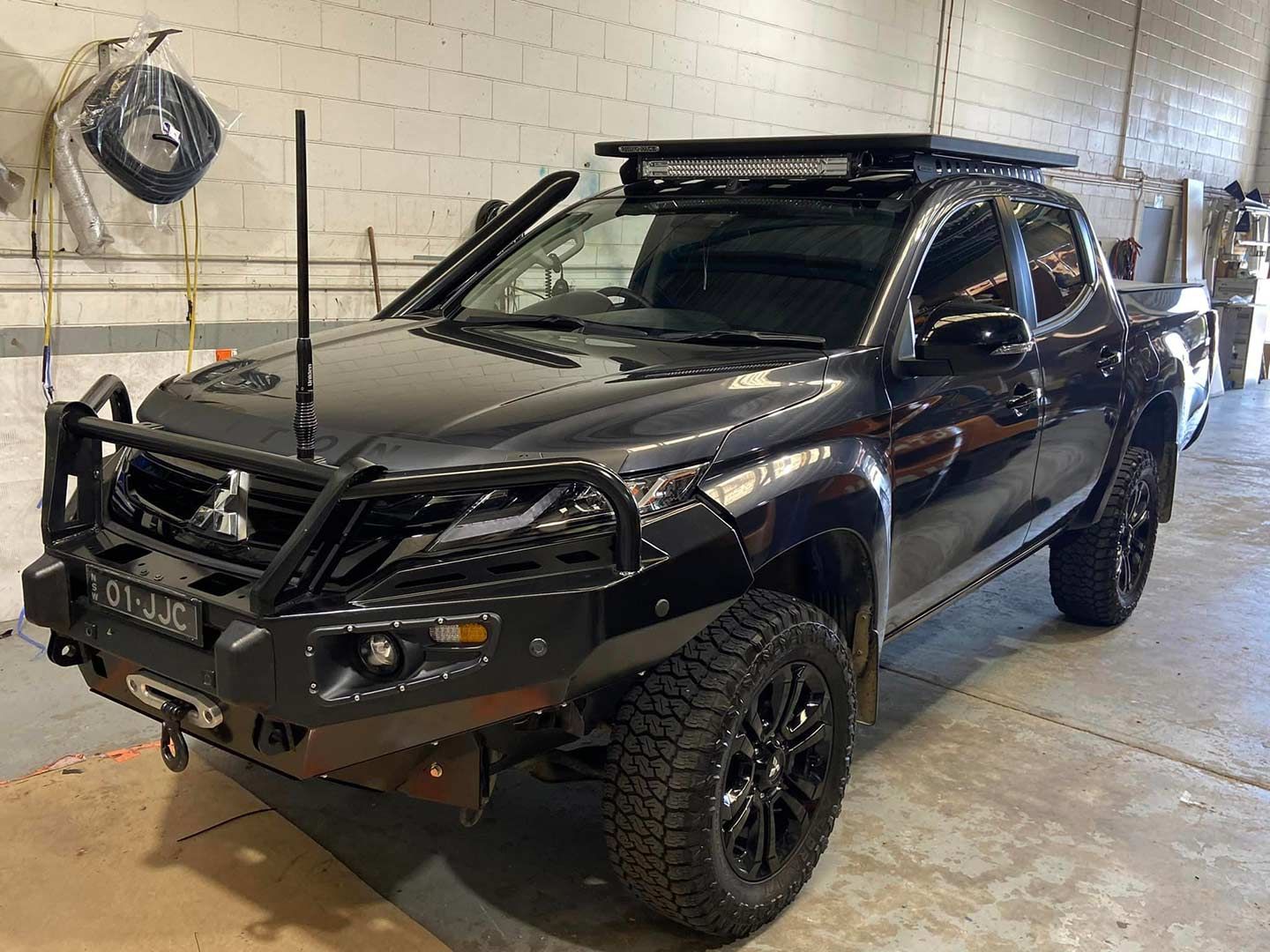 A Black Truck with A Roof Rack Is Parked in A Garage — Motor Accessories Direct In Tweed Heads South, NSW
