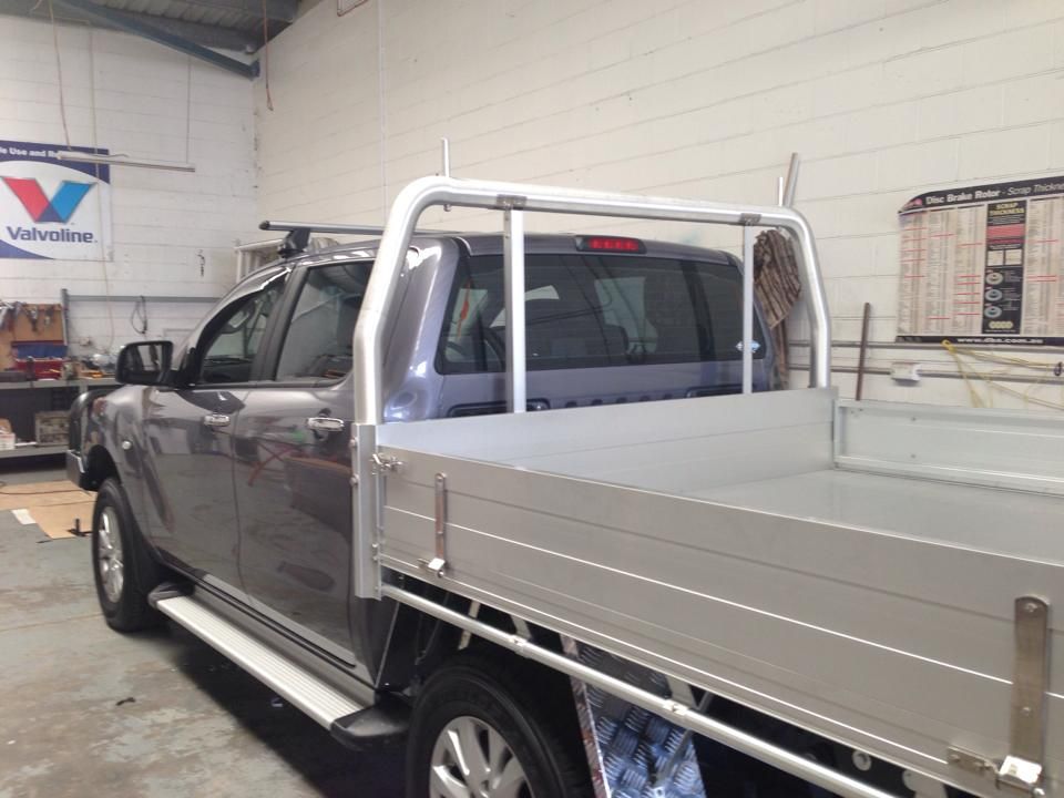A Gray Pickup Truck With a Flatbed, Roll Bar, and Silver Bed, in a Garage — Motor Accessories Direct In Burleigh Heads, QLD