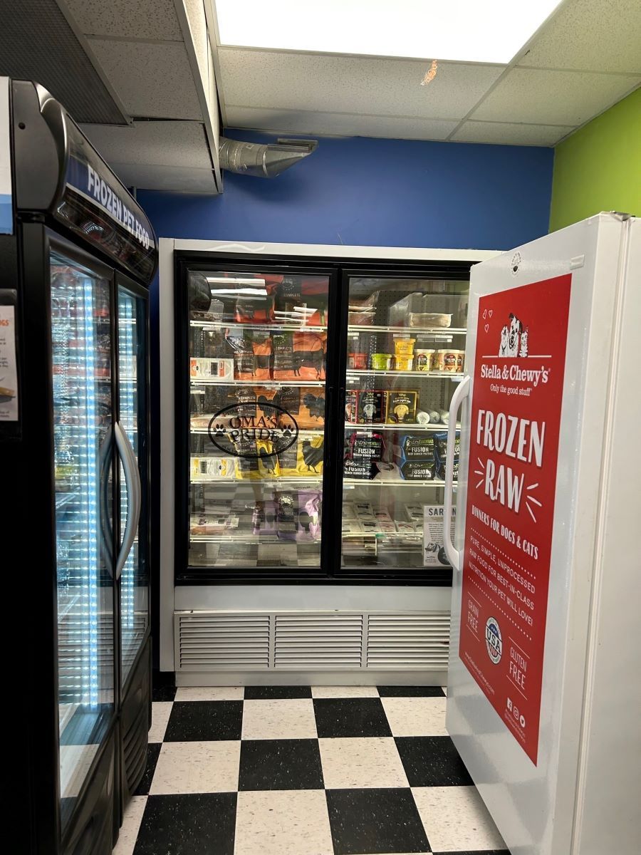 A refrigerator with a sign on it that says frozen raw