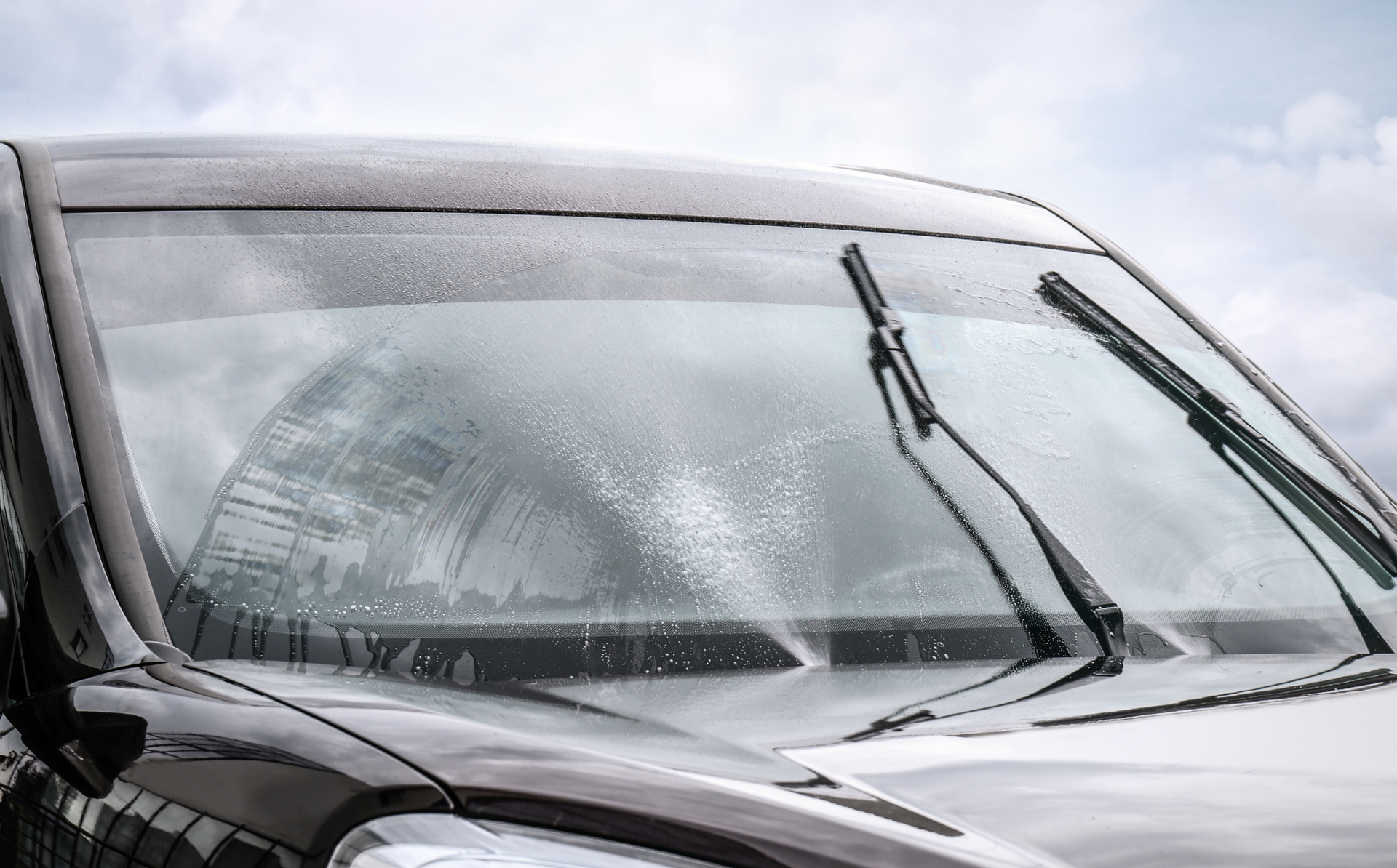 Windshield wipers clearing rain from a car windshield