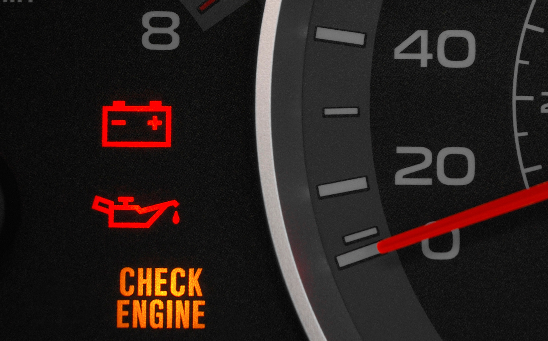 Car dashboard warning lights glowing red and amber