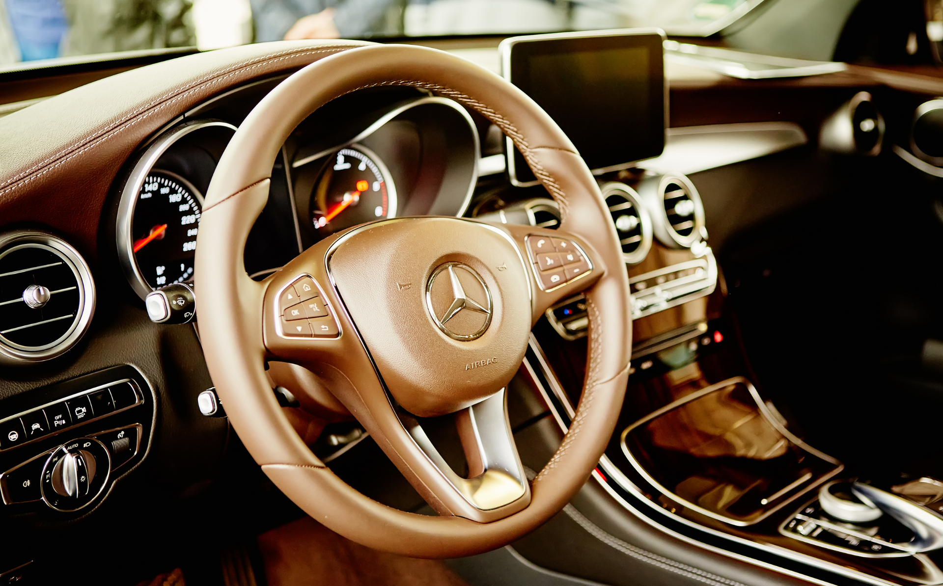 Mercedes-Benz luxury interior with tan leather steering wheel and dashboard