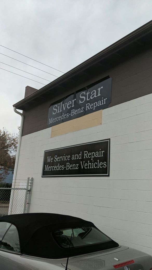 Storefront with signs for “Silver Star Auto Repair & Tires” and “B & B Repair & Tire Services,” with a parked car below.