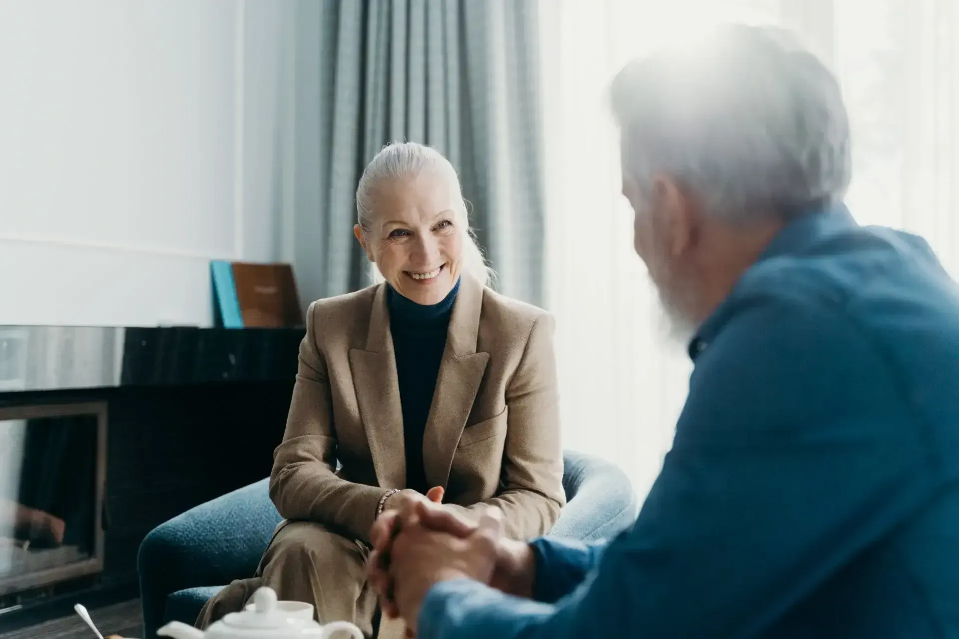 Mature couple talking in a warm setting featured in an article about the CARE processed used by savvy senior living advisors