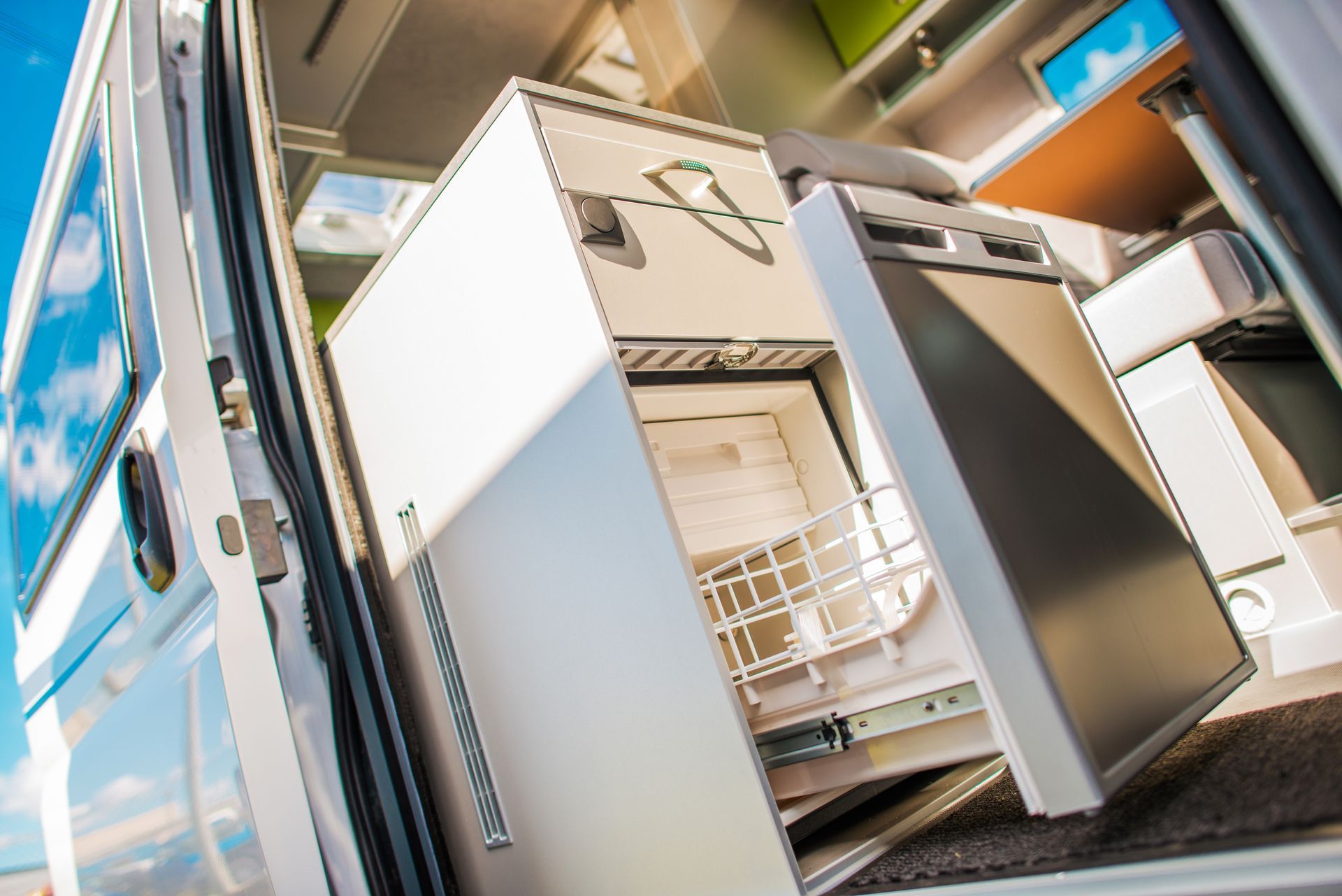 Open dishwasher with dishes inside in a modern kitchen
