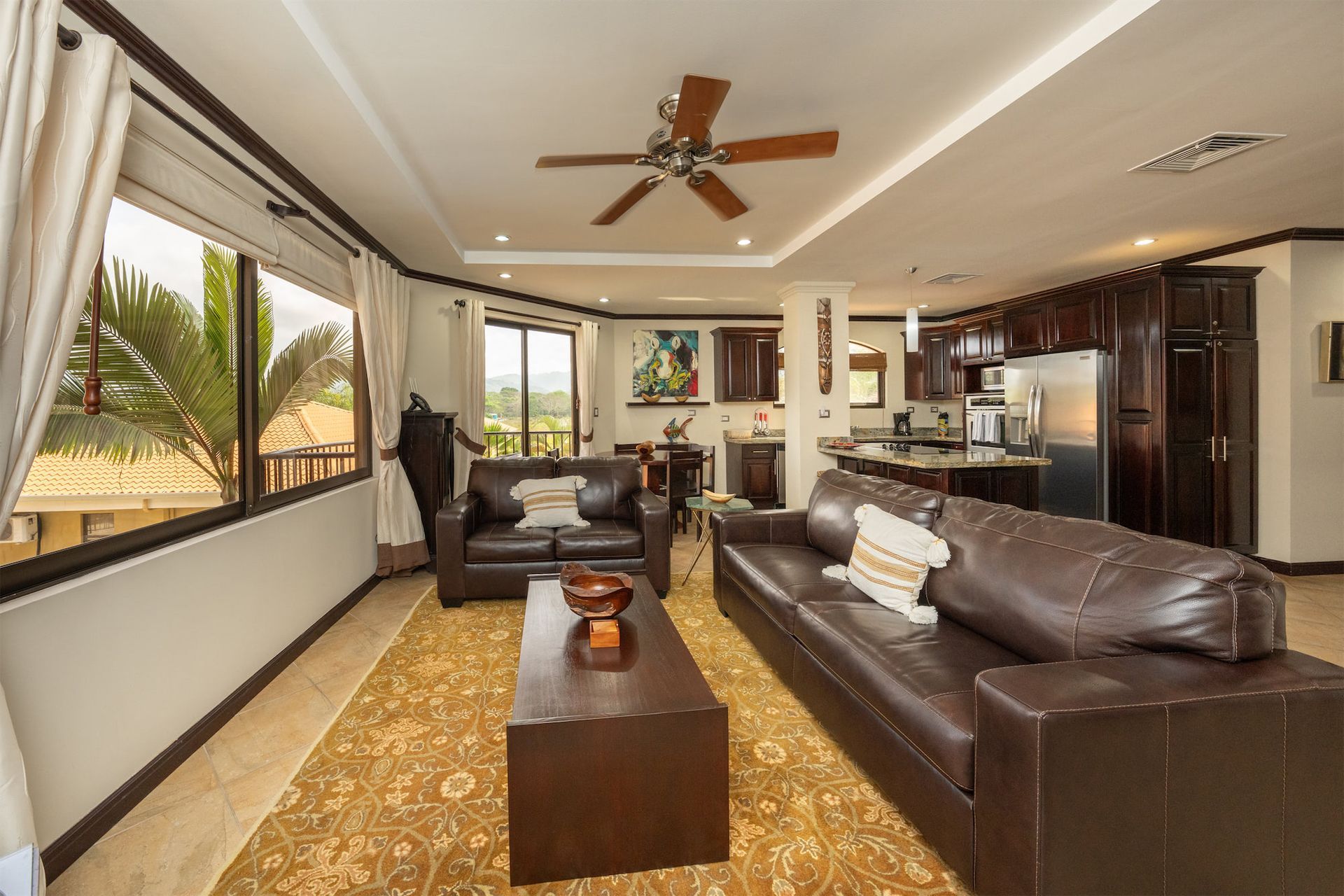 A living room filled with furniture and a ceiling fan