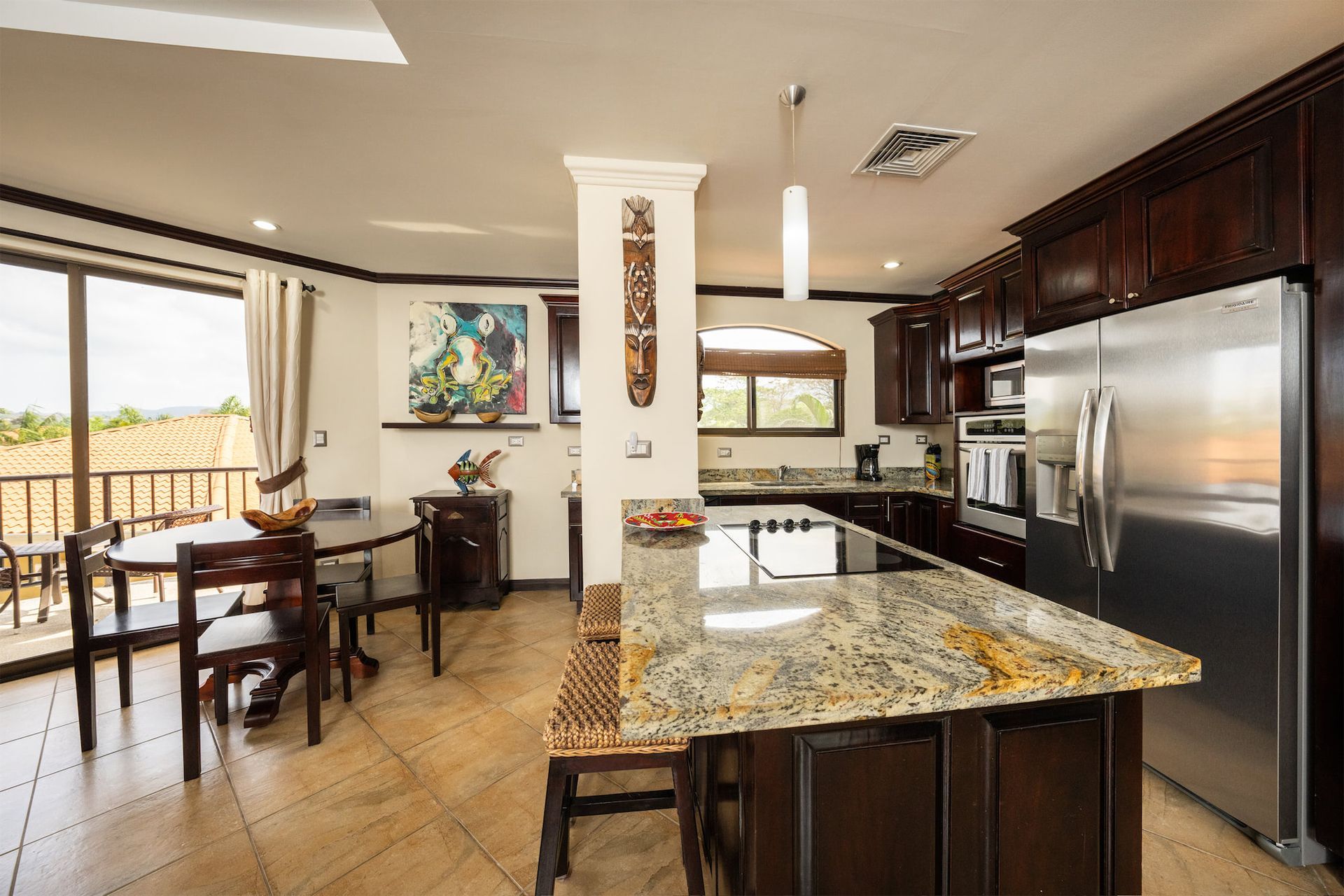 A kitchen with granite counter tops and stainless steel appliances