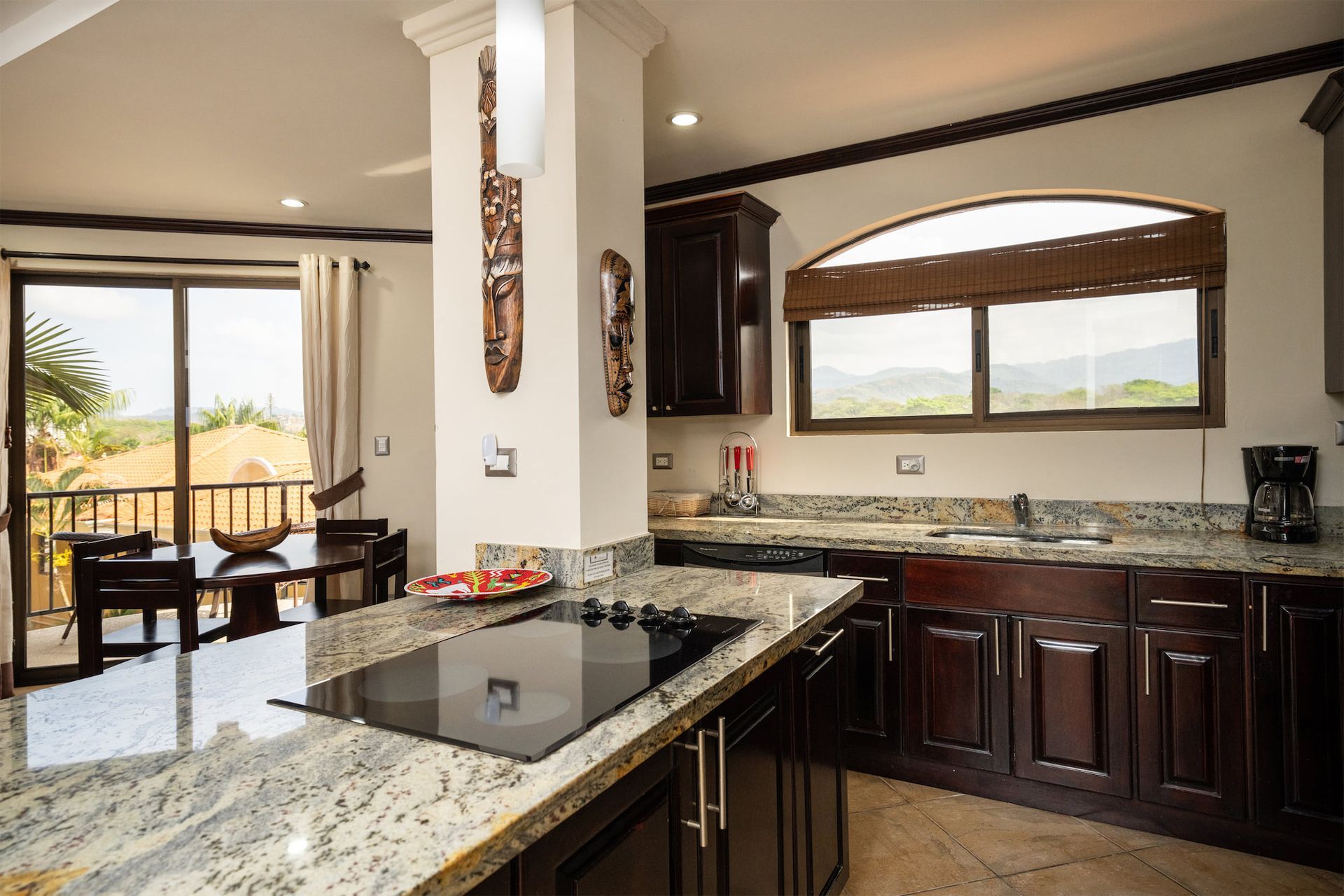 A kitchen with granite counter tops and a stove top oven