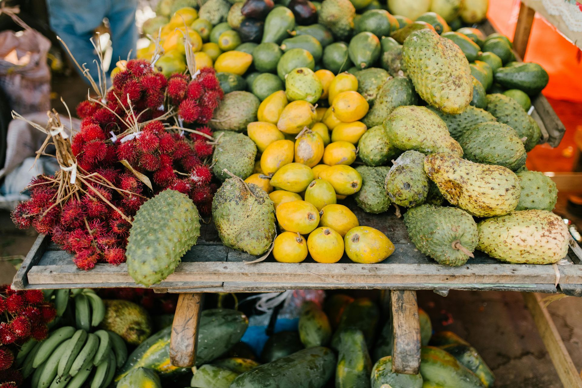A wooden table topped with a variety of fruits and vegetables.