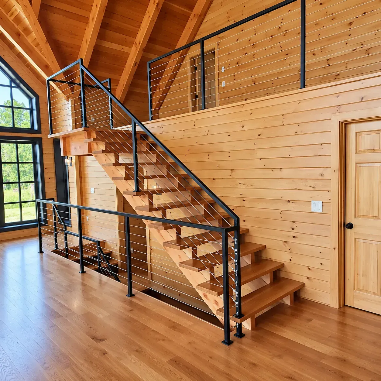 Open floating staircase with interior cable railing in a log home