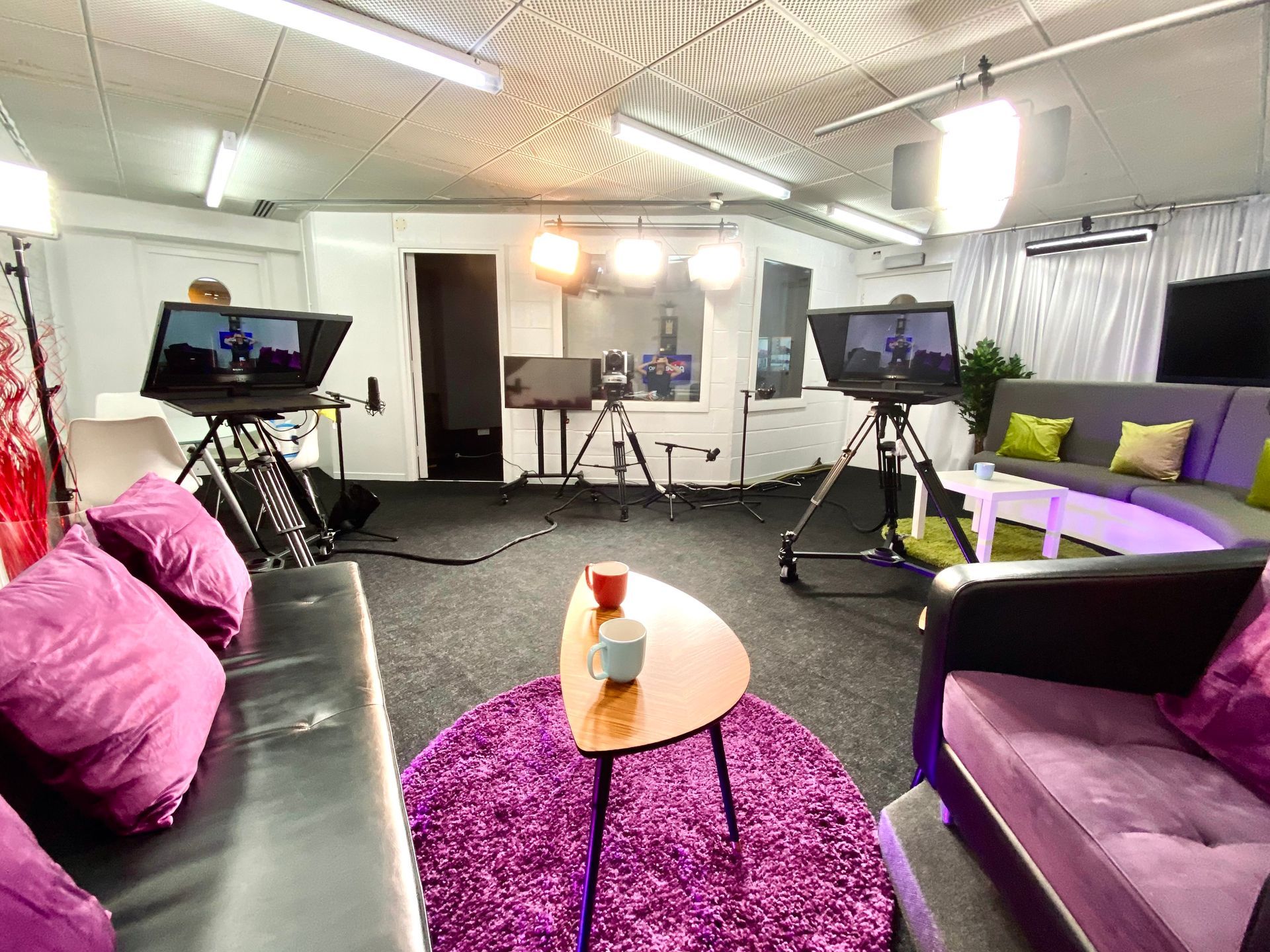 Pride Media Centre studio lounge with cameras, lighting and broadcast recording booth