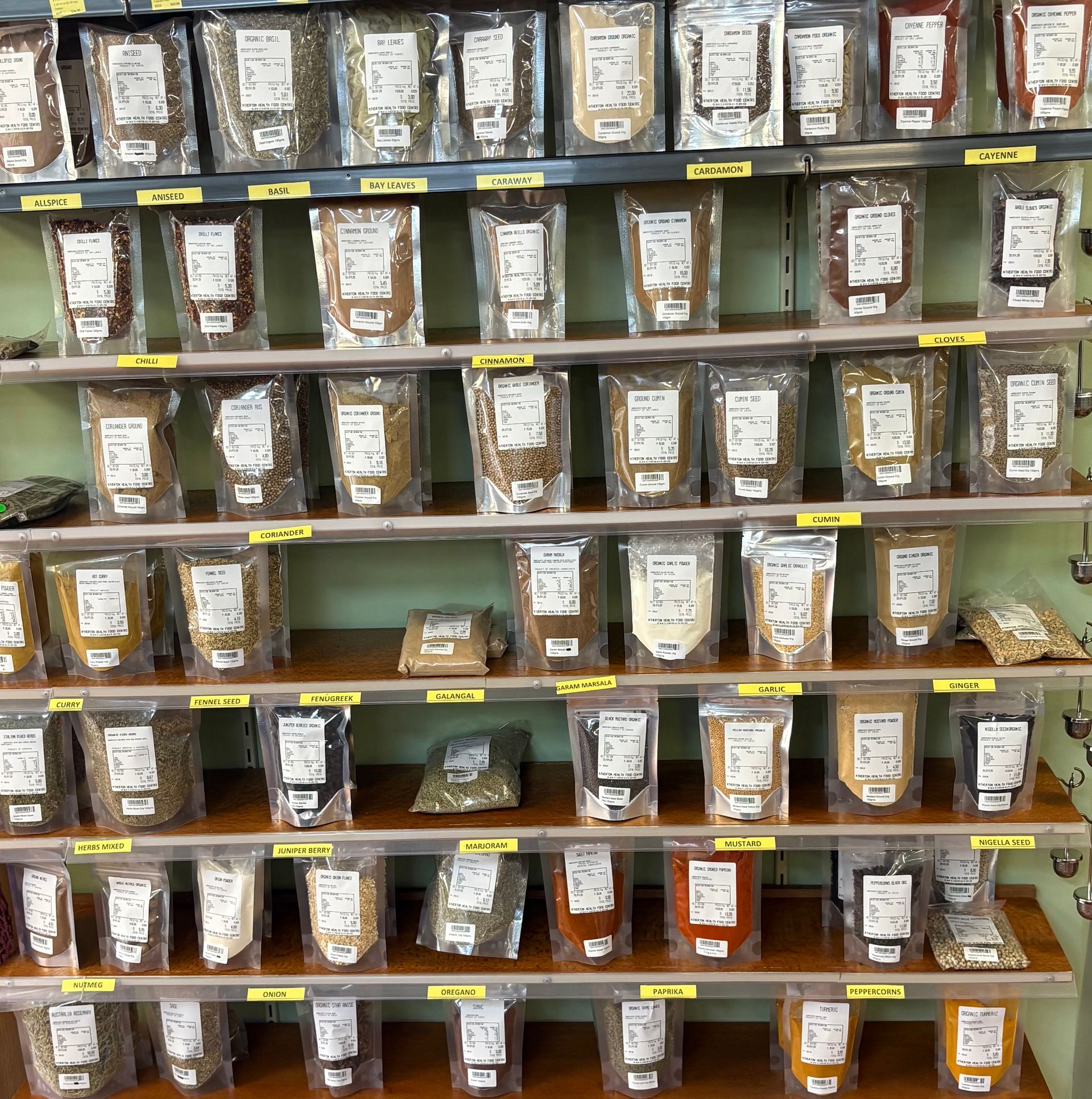 A Variety of Food Items Are Sitting on a Wooden Table — Atherton Health Food Centre in Atherton, QLD