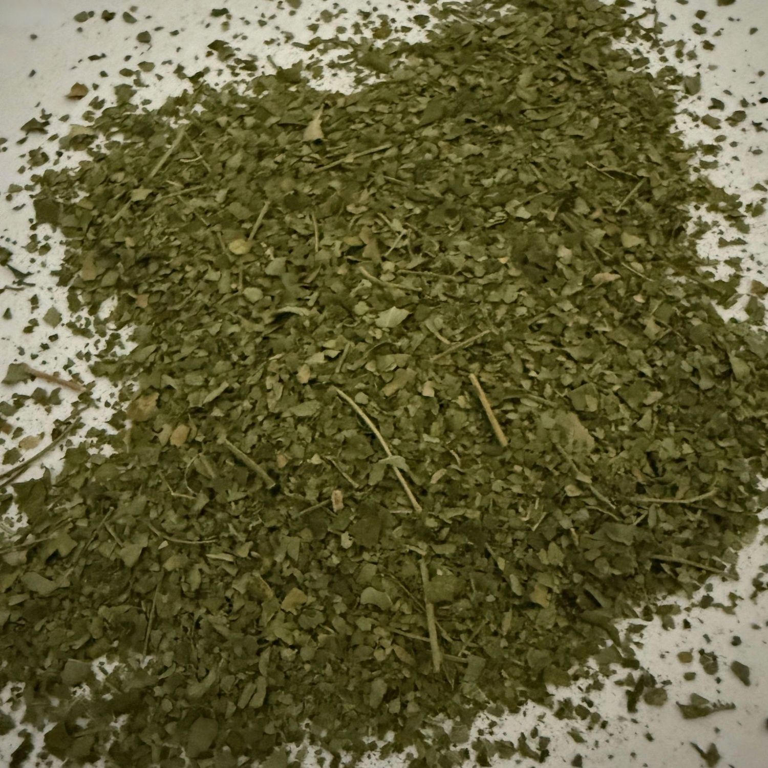 A pile of green leaves on a white surface— Atherton Health Food Centre in Atherton, QLD