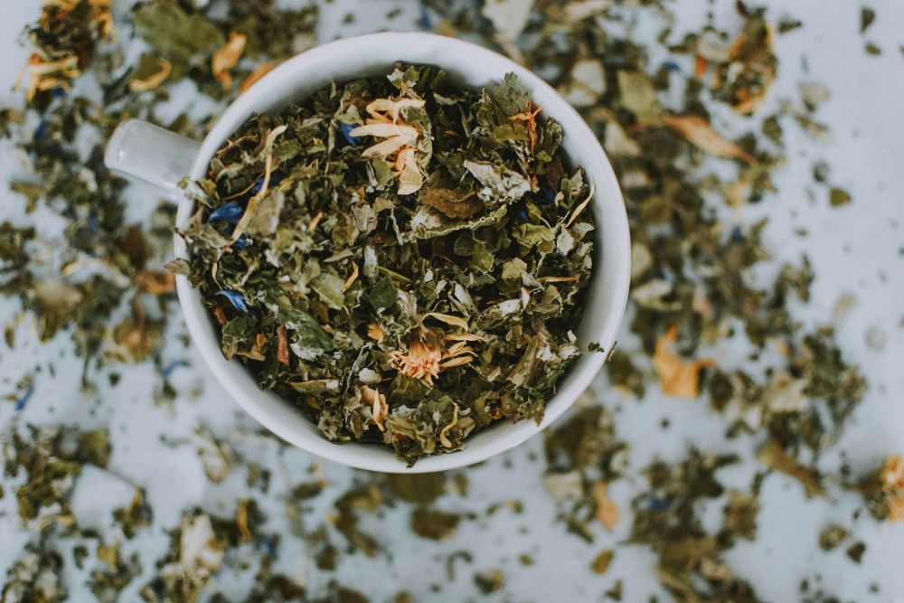 A Bag of Pine Needle Fusion Tea With a Cup and Saucer — Atherton Health Food Centre in Atherton, QLD