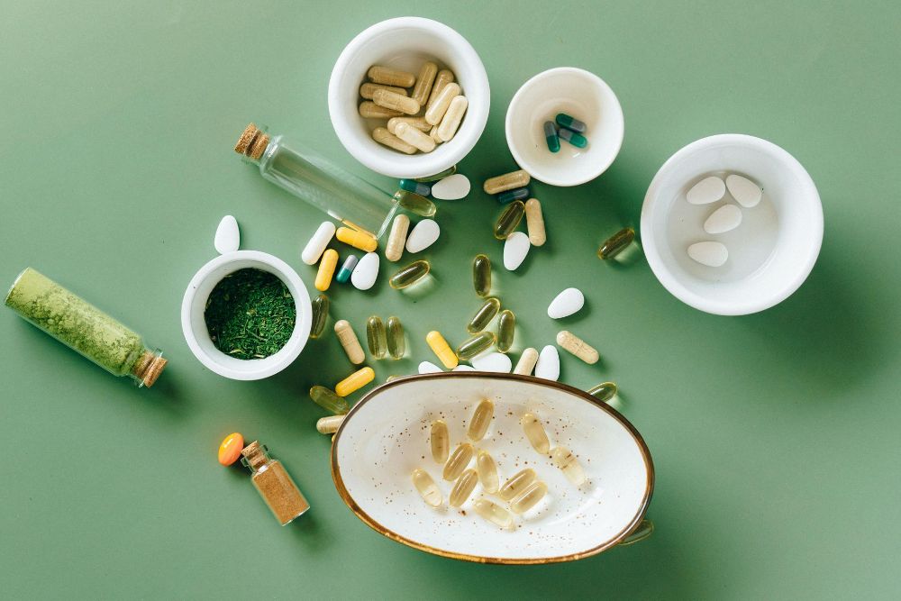 A Wooden Spoon is Sitting on a Wooden Table Surrounded by Nuts and Seeds — Atherton Health Food Centre in Atherton, QLD