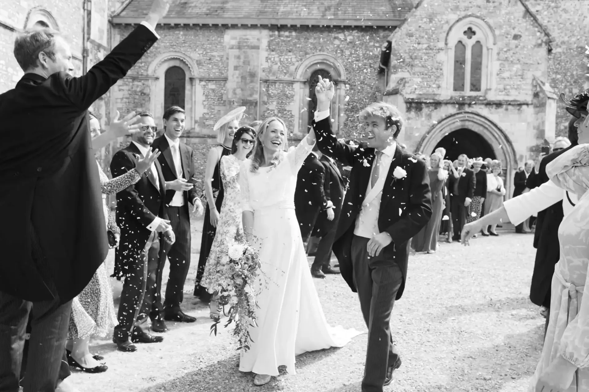 A black and white photo of a bride and groom posing for a picture.