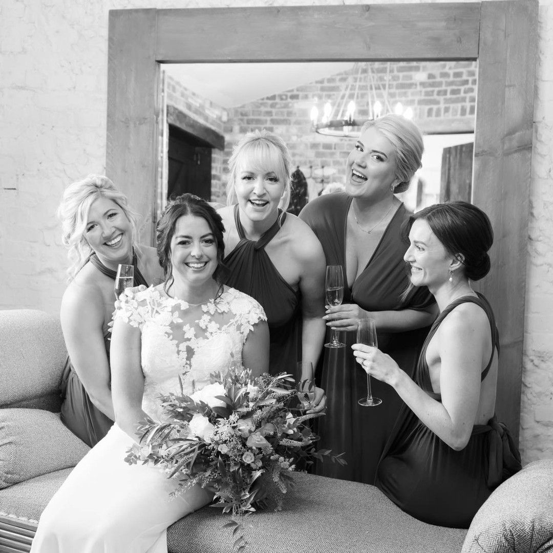 Black and white wedding photography of bride and bridesmaids at Clock Barn in Hampshire