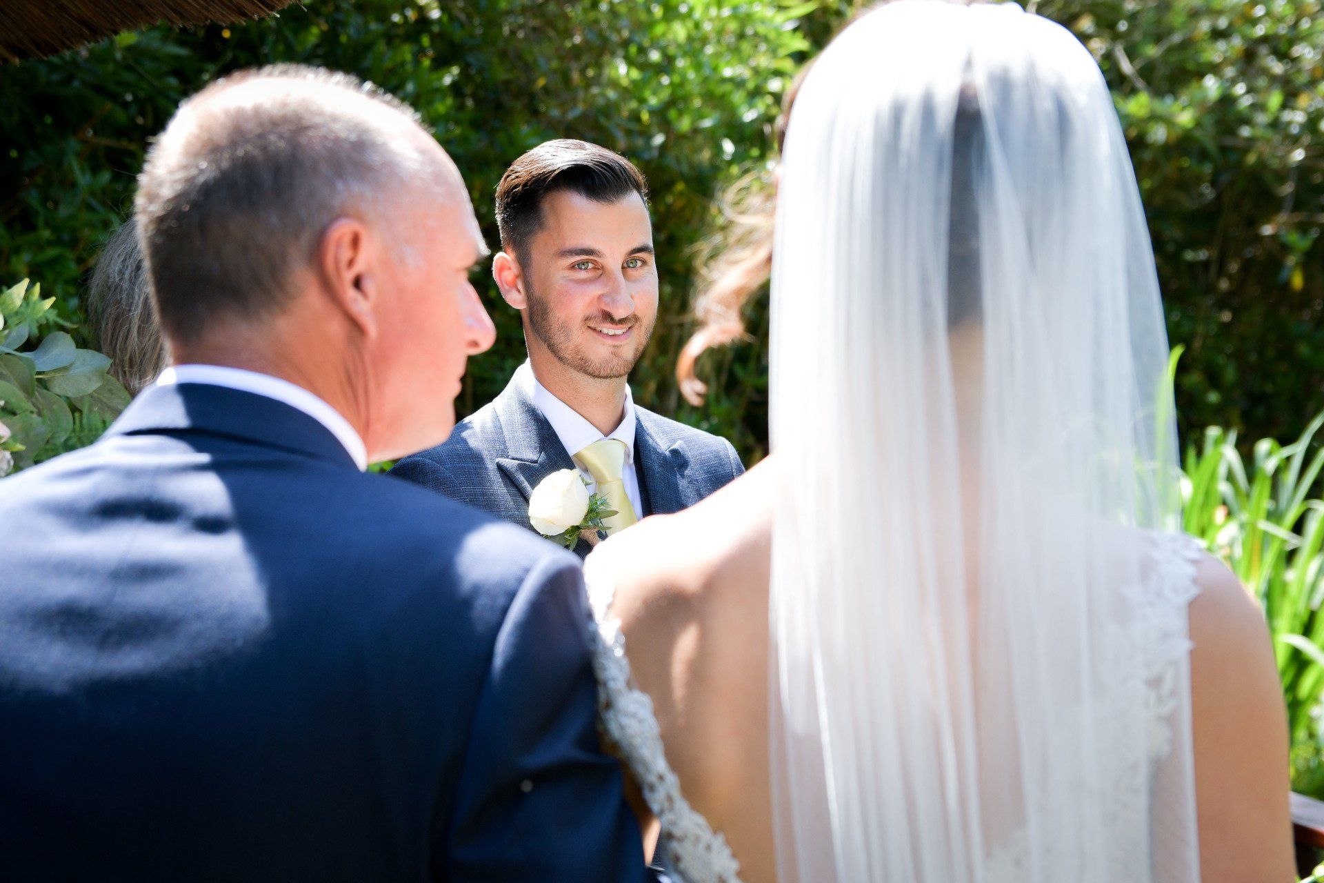 A bride and groom are standing next to each other at a wedding ceremony.