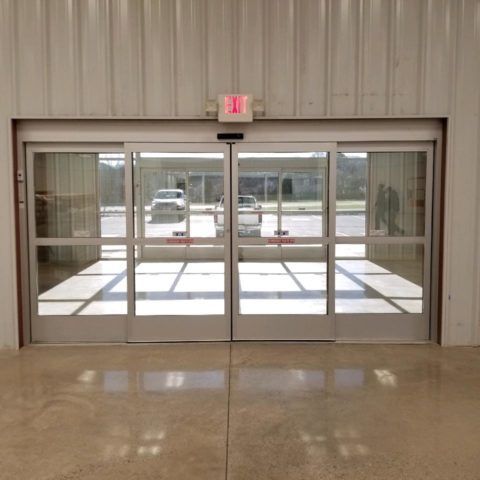 Automatic Doors Installation and Repair - A sliding glass door with an exit sign above it