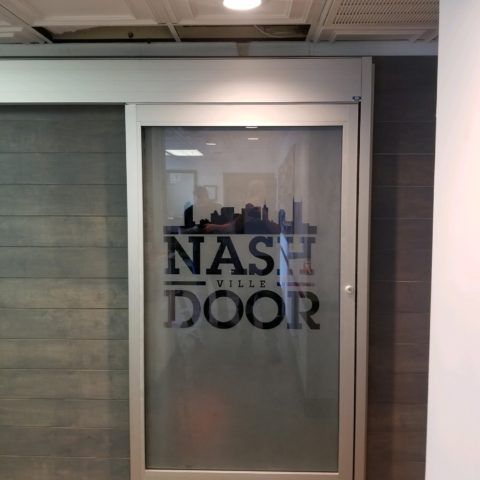 A nashville door with a city skyline on it