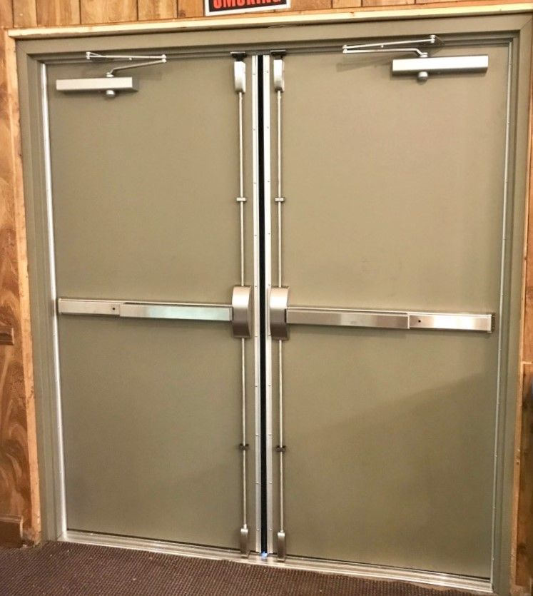 Hollow Metal Doors Installation and Repair - A pair of doors with a caution sign above them