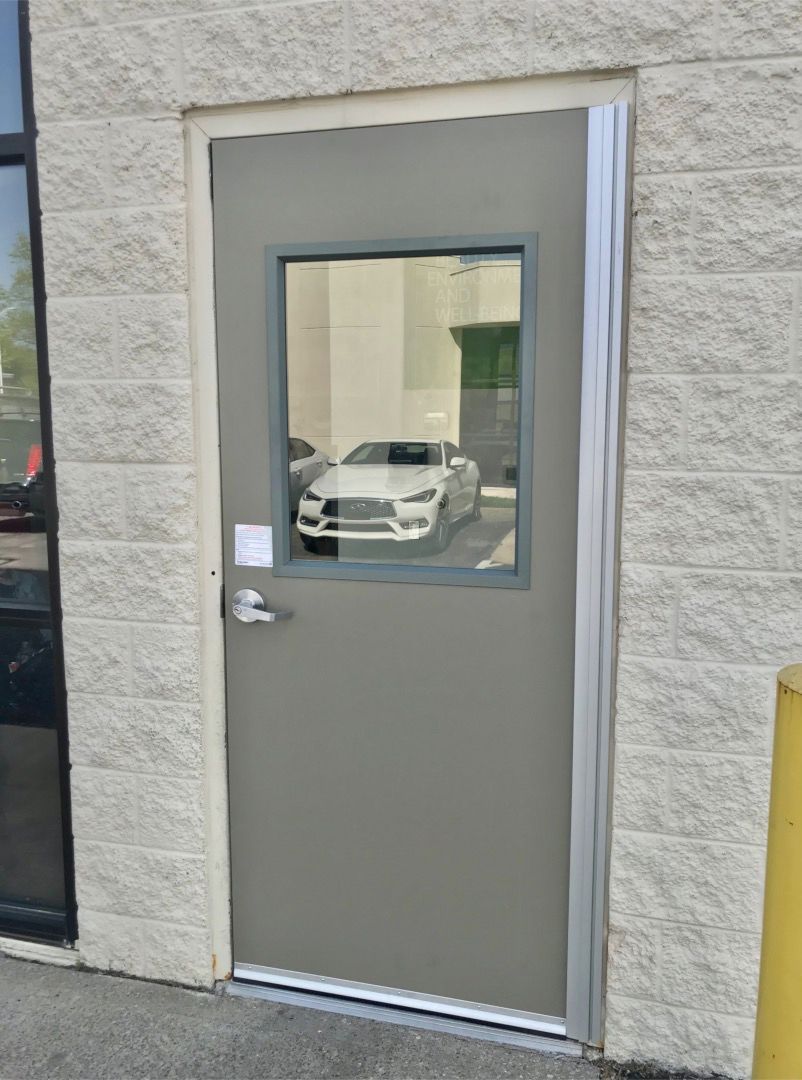 Hollow Metal Doors Installation and Repair - A door with a window on it and a car behind it.